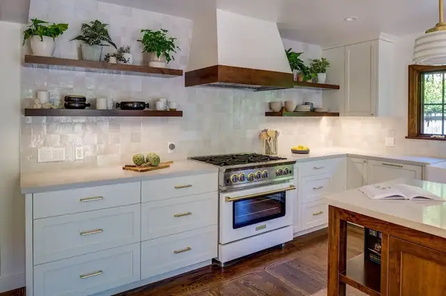 Oakland kitchen remodel with white cabinets, floating wood shelves, white tile backsplash and a white range with a plaster hood