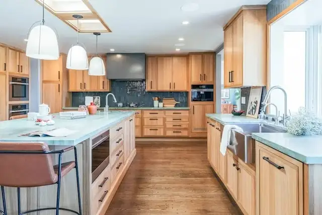 Grizzly Peak kitchen remodel in Berkeley by HDR Remodeling with wood cabinets, a long island, white pendant lights and a blue tile backsplash