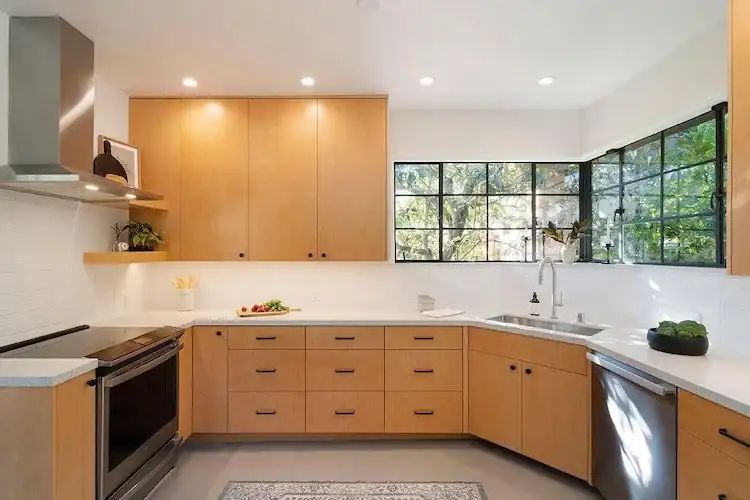 Kitchen remodeling Berkeley: Park Hills kitchen with natural wood cabinets, steel-framed corner windows and white quartz counters